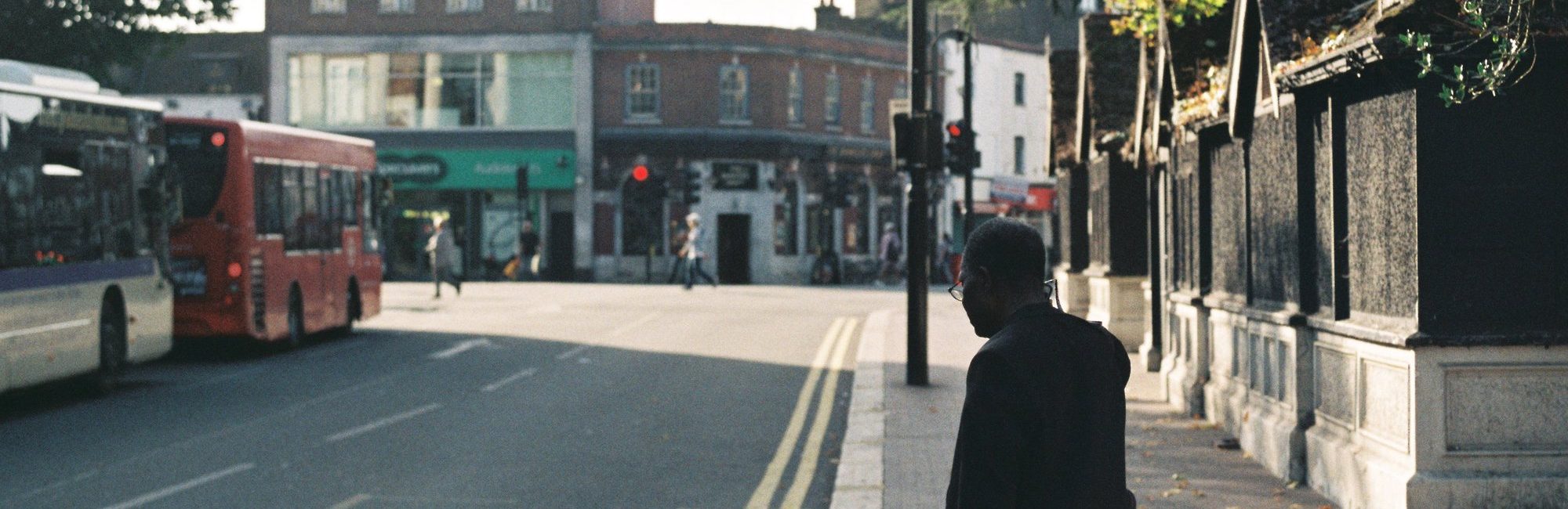 A man waiting at a bus stop